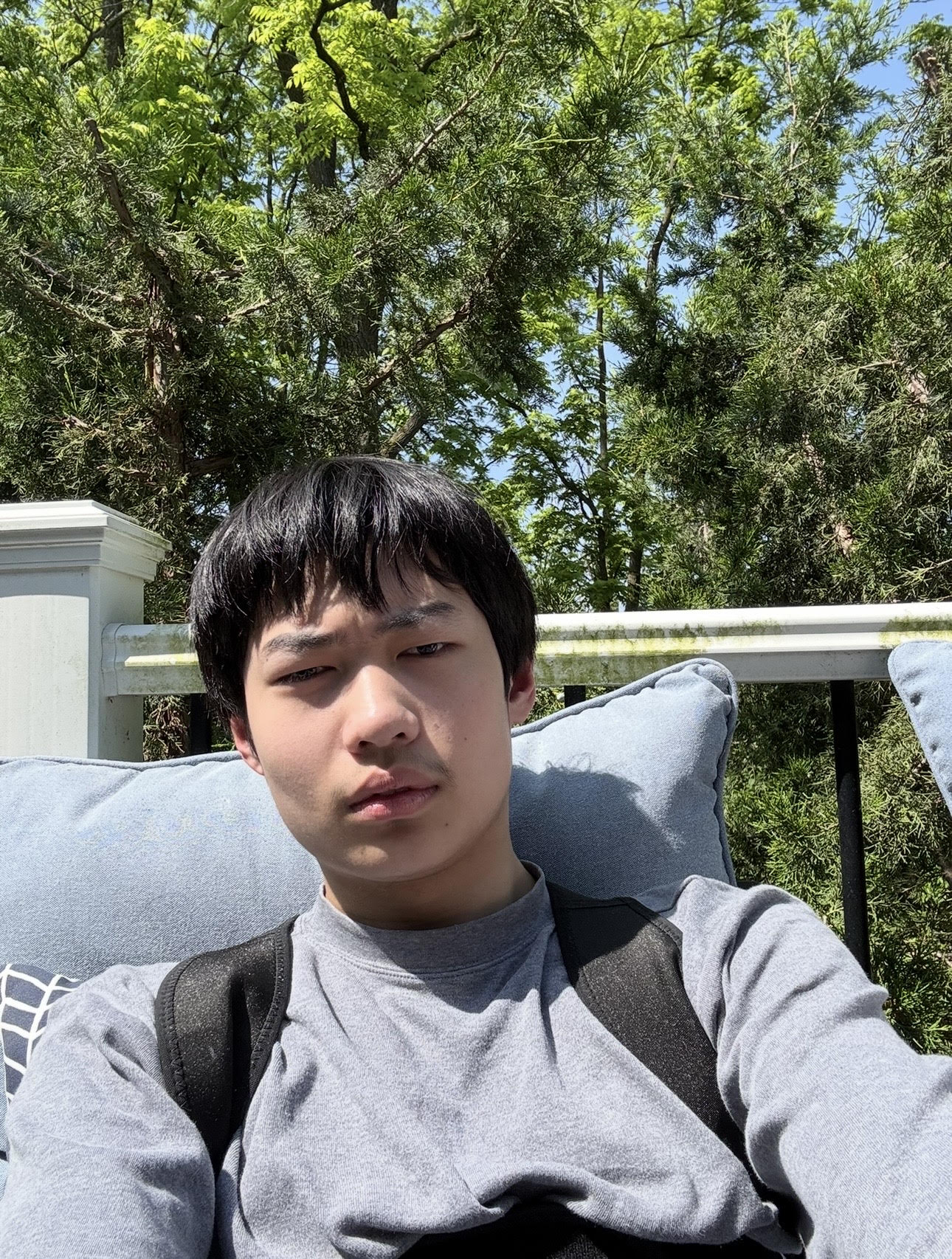 Nick Chen sitting outside in the sunshine